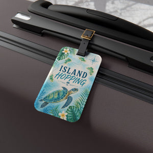 Island Hopping cruise luggage tag with sea turtle, tropical islands, flowers, palm leaves, and black strap