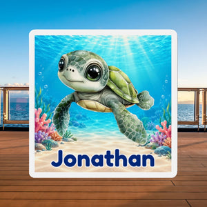 Square personalized cruise door magnet with a blue baby sea turtle, underwater coral scene