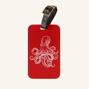 Red Octopus Cruise luggage tag with white vintage octopus artwork and adjustable black leather strap.