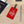 Red Octopus Cruise luggage tag with white vintage octopus artwork and adjustable black leather strap.