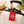 Red Octopus Cruise luggage tag with white vintage octopus artwork and adjustable black leather strap.