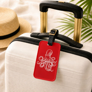 Red Octopus Cruise luggage tag with white vintage octopus artwork and adjustable black leather strap.